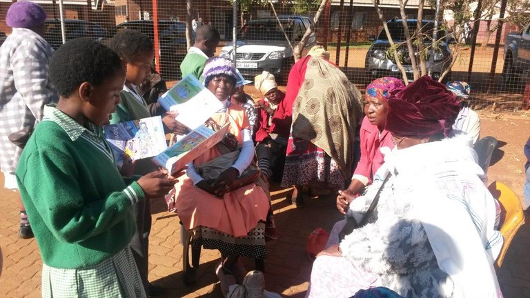 Learners reading to parents